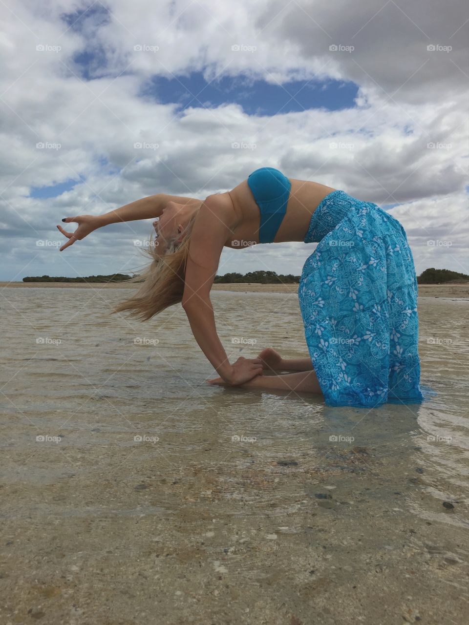 Young woman given posing on beach