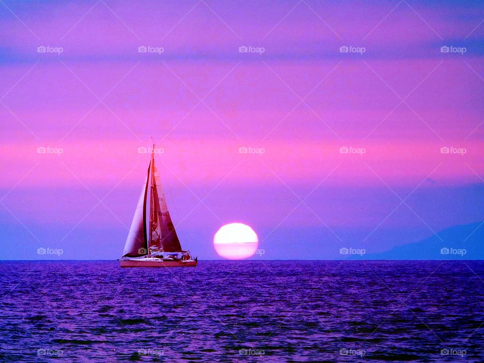 The Sun behind  the sailboat. (Palinuro - Italy ).