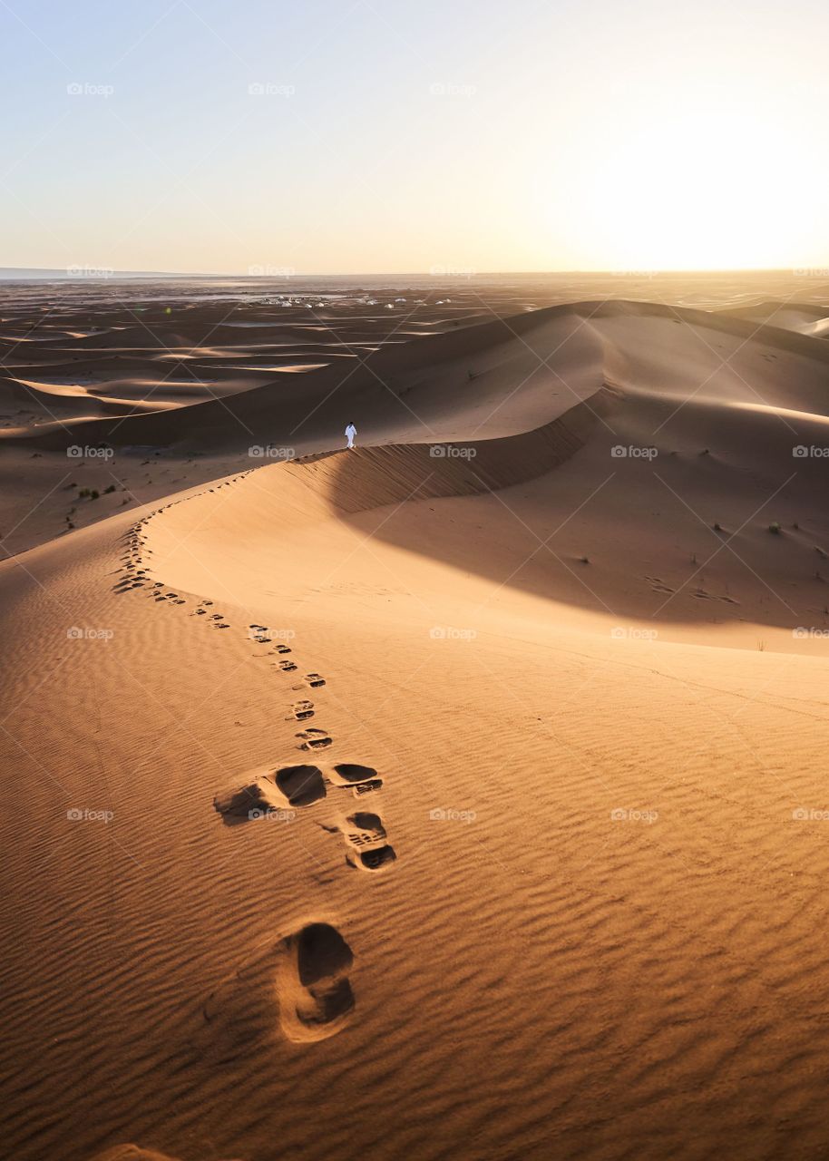 Human foot prints on sea sand