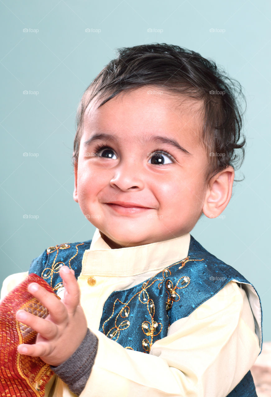 Smiling Indian baby boy in traditional clothes