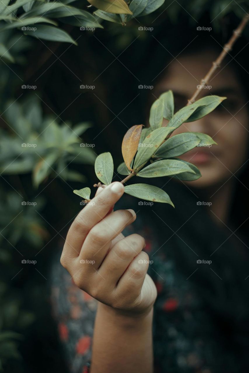 a woman holding a plant in her hand

Spring days of her life.