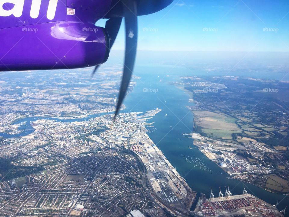 View of a port from a plane window in the sunlight