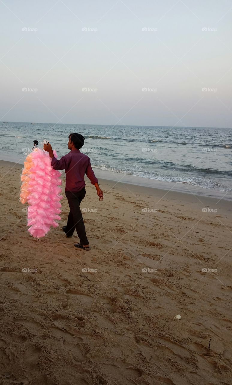 Man selling cotton candy by the beach
sea beach
vendor
colorful