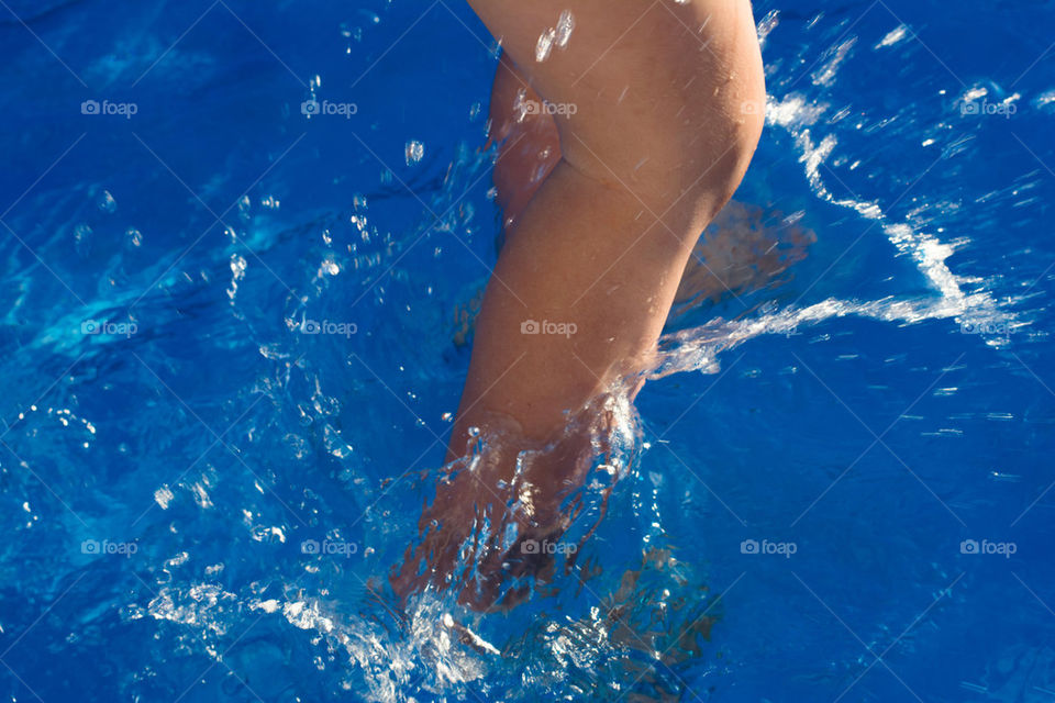 kid splashing in the pool