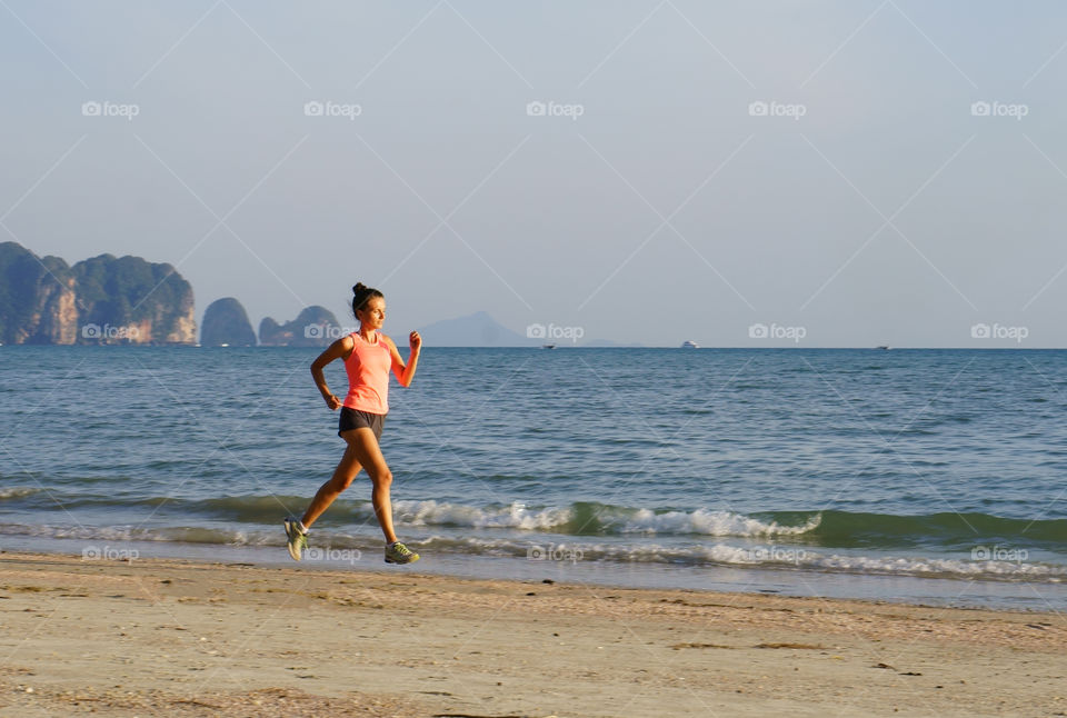 Girl jogging on a beach