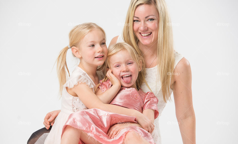 Happy family, mother with her two daughters of 6 and four years old.