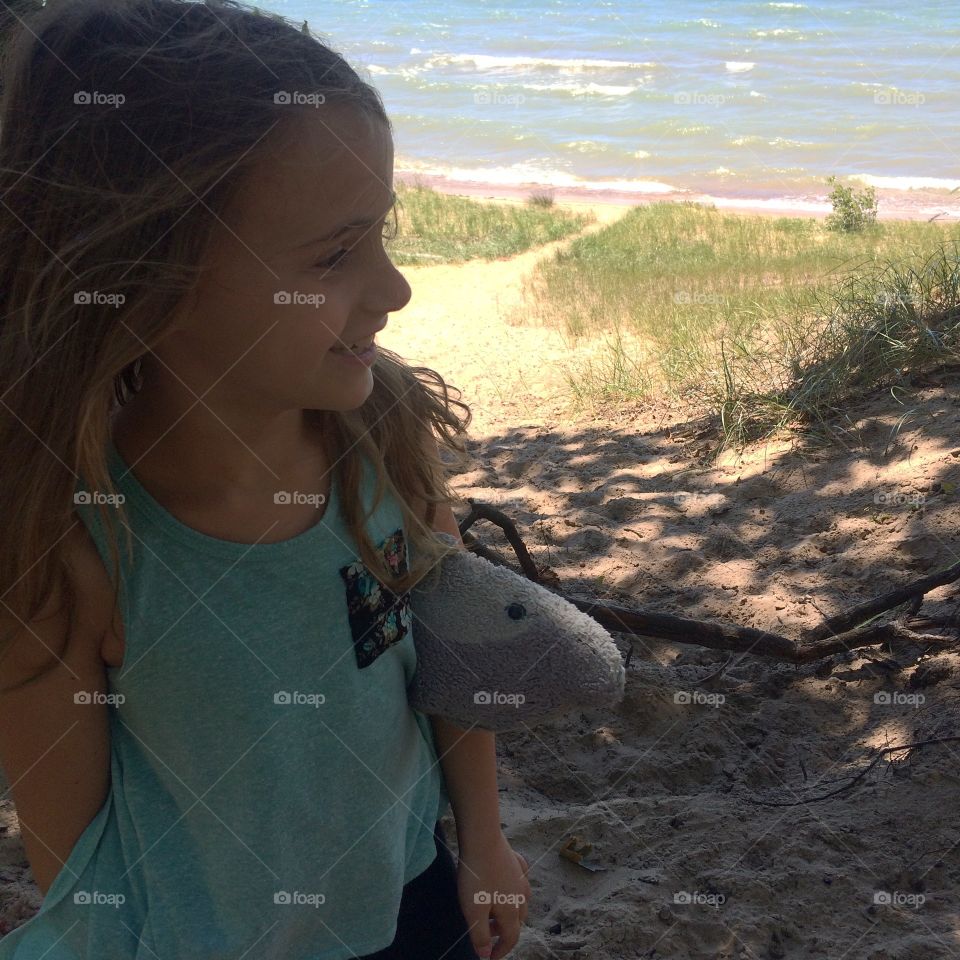 Girl at the beach with her dolphin 