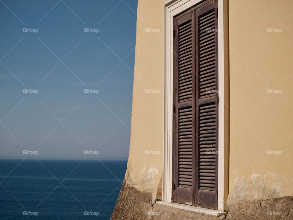 rectangular wooden window with sea view