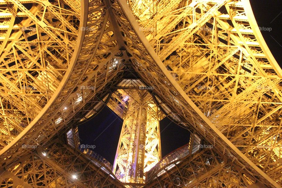 Gloving Eiffel Tower in Paris at night bottom view 