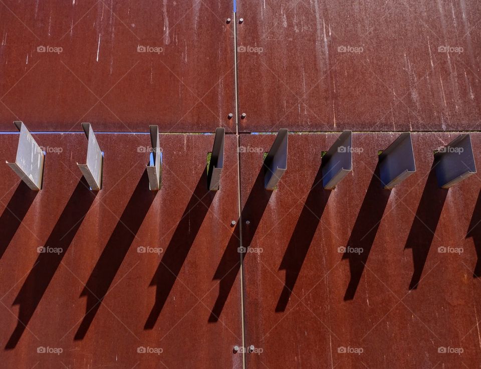 Steel slates protruding vertically on old rust iron wall Scottsdale Arizona