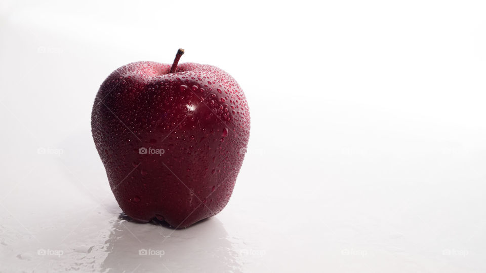 Studio shot of wet red apple