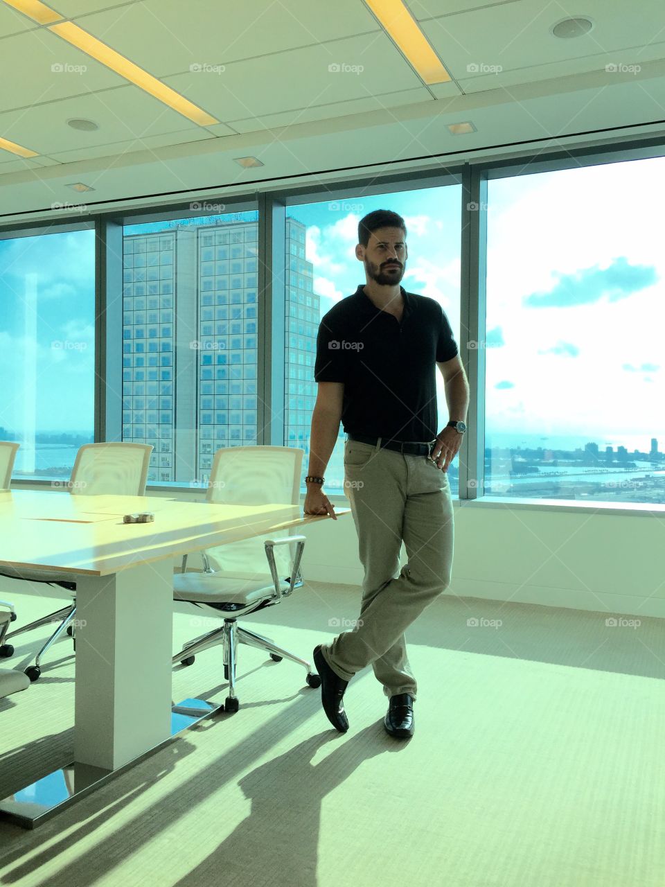 Success . Young man standing by office table