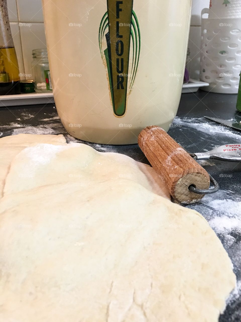 Old fashioned baking, vintage 1940s flour bin canister, flour dough, rolling pin, dough on counter for homemade pita bread