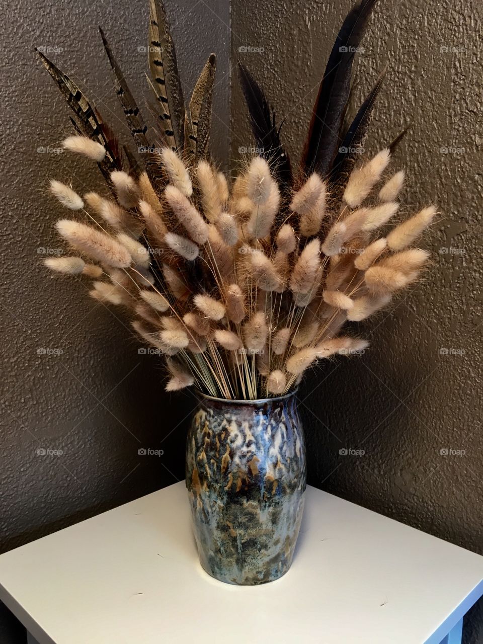 Dried floral arrangement in ceramic vase