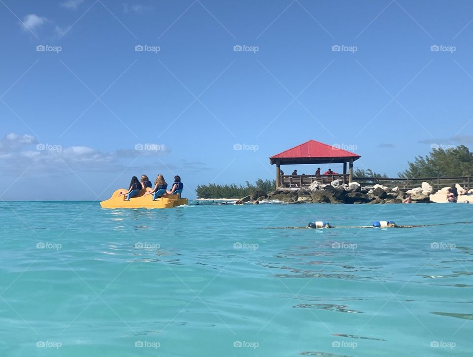 People in a paddle boat on the ocean island or vacation