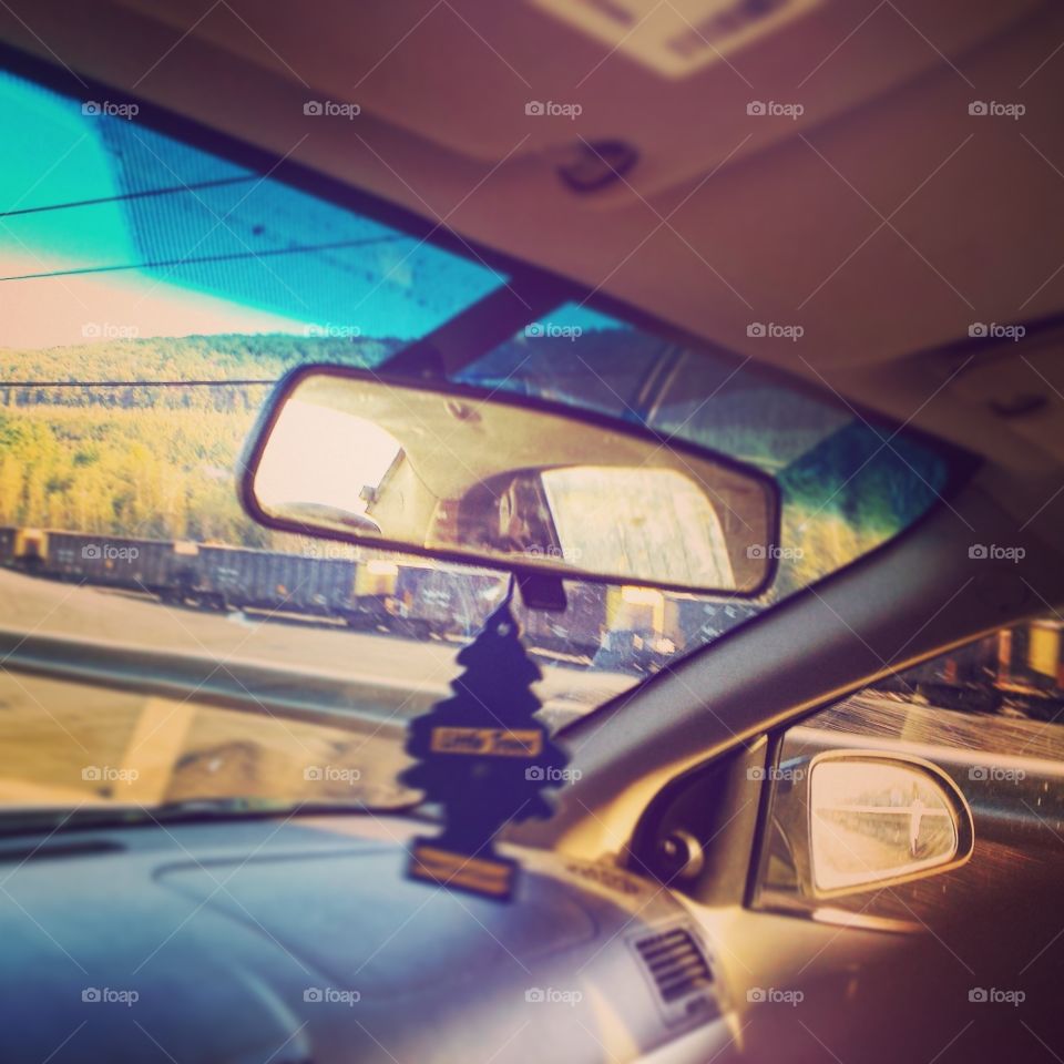 Car rear view mirror with an air freshener.