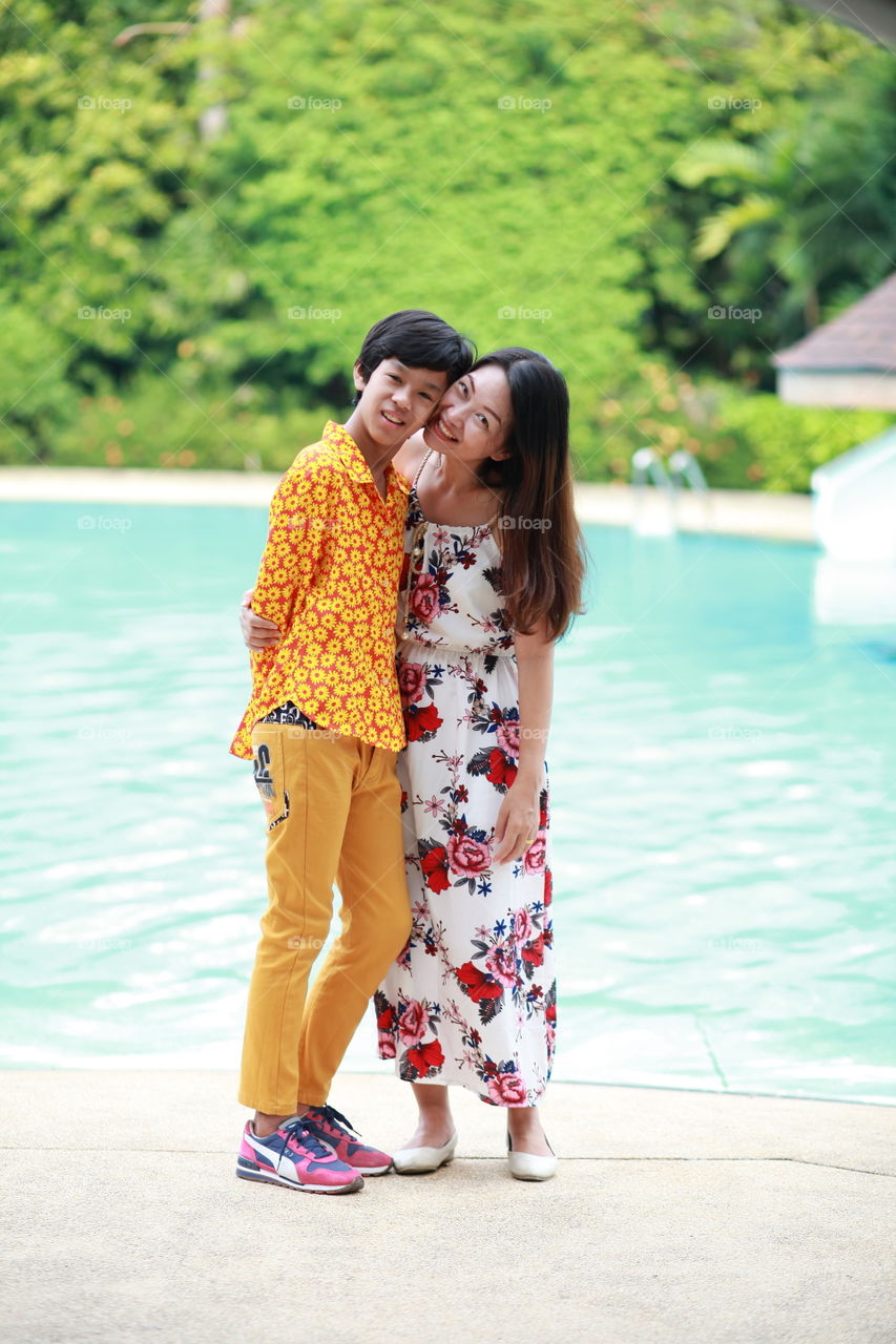 Mother and son wearing colorful dress enjoy their vacation
