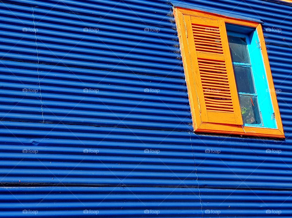 orange window on a blue wall