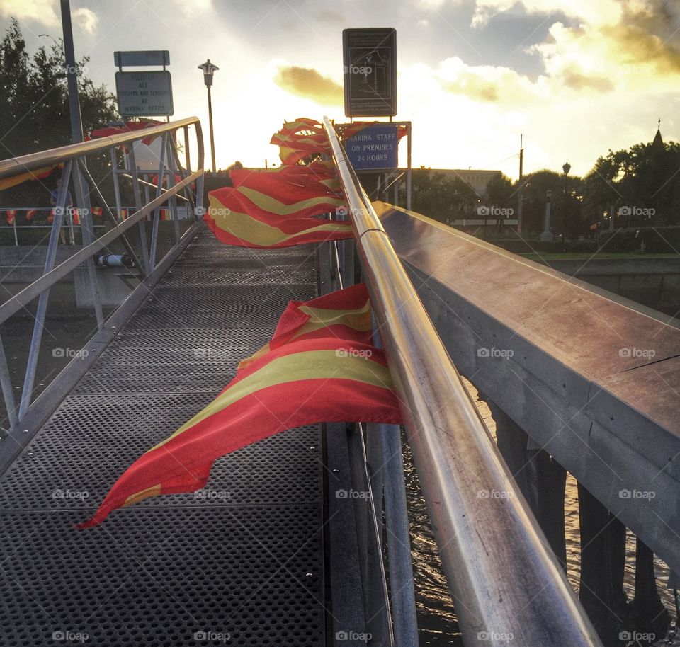 Red and yellow. Red and yellow flags leading down to a marina 