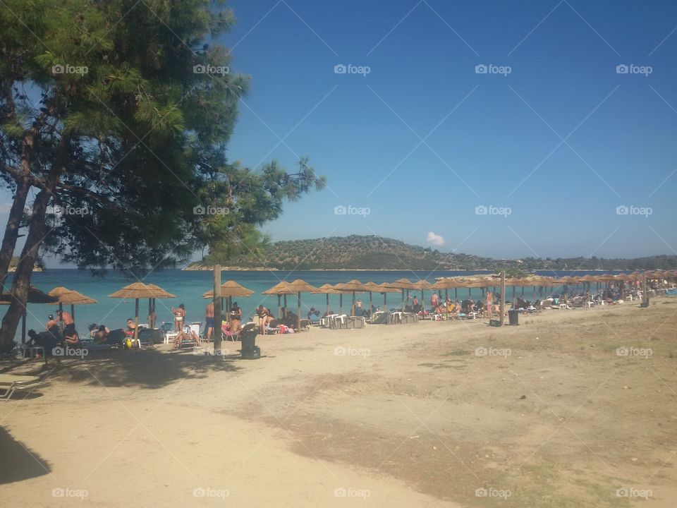 Sand beach with blue sea water