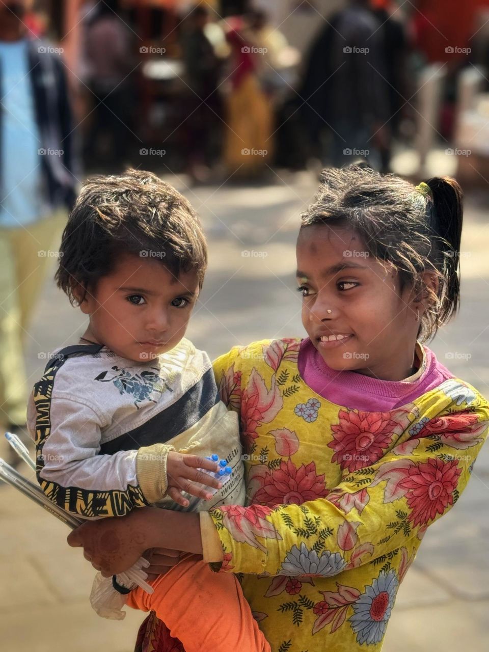 portrait of begger girl with her little brother