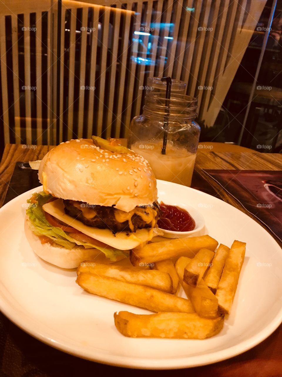 burger with fries and ice coffee 