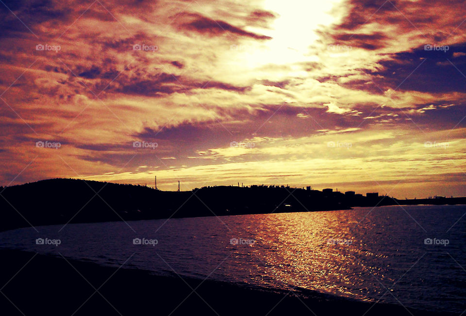 amazing sky, sea, hill and sunset. harbor bar