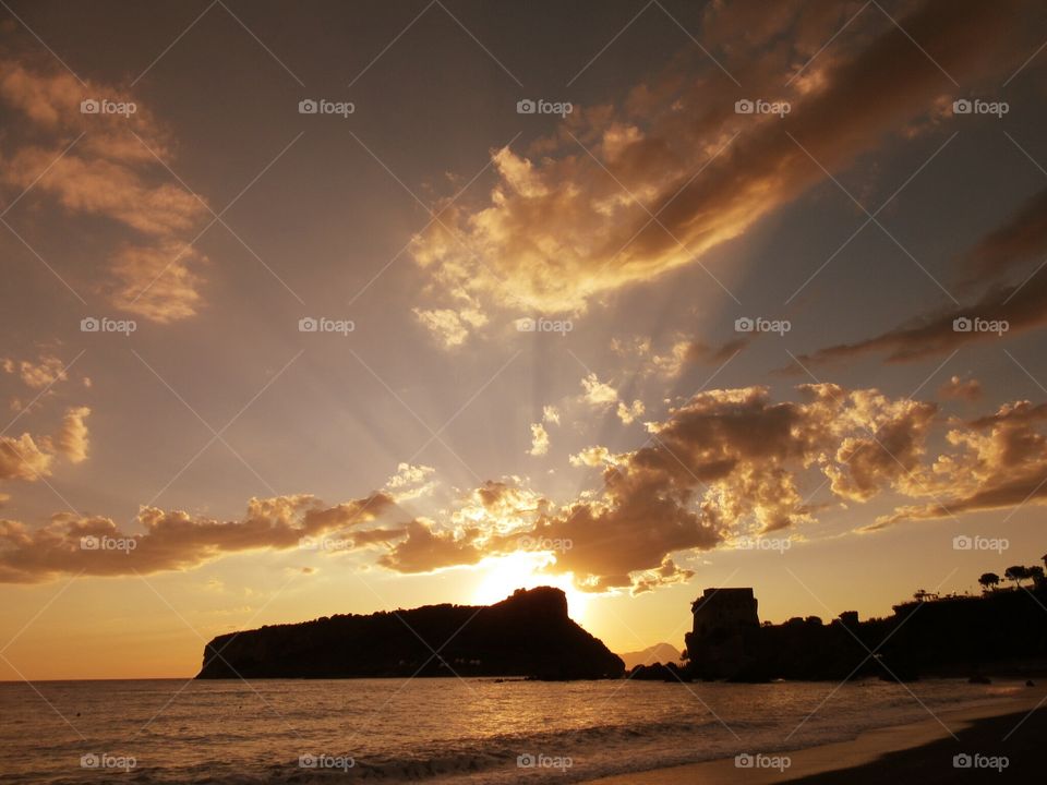 Rays of light   over Islet of Dino  ( Italy ).