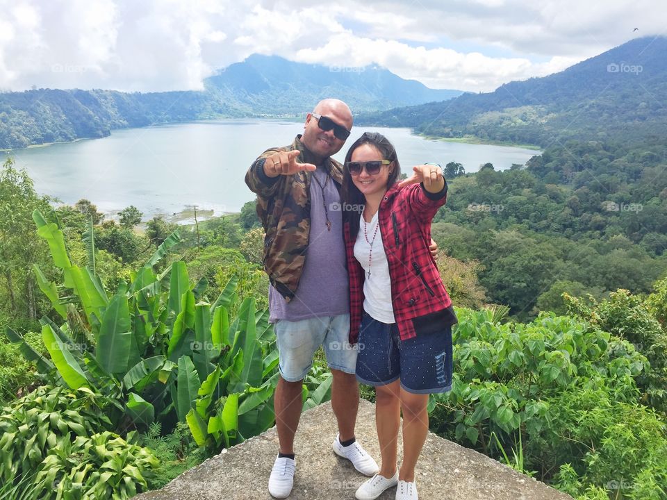 Hug and smile from great view in bali, twin Lake.