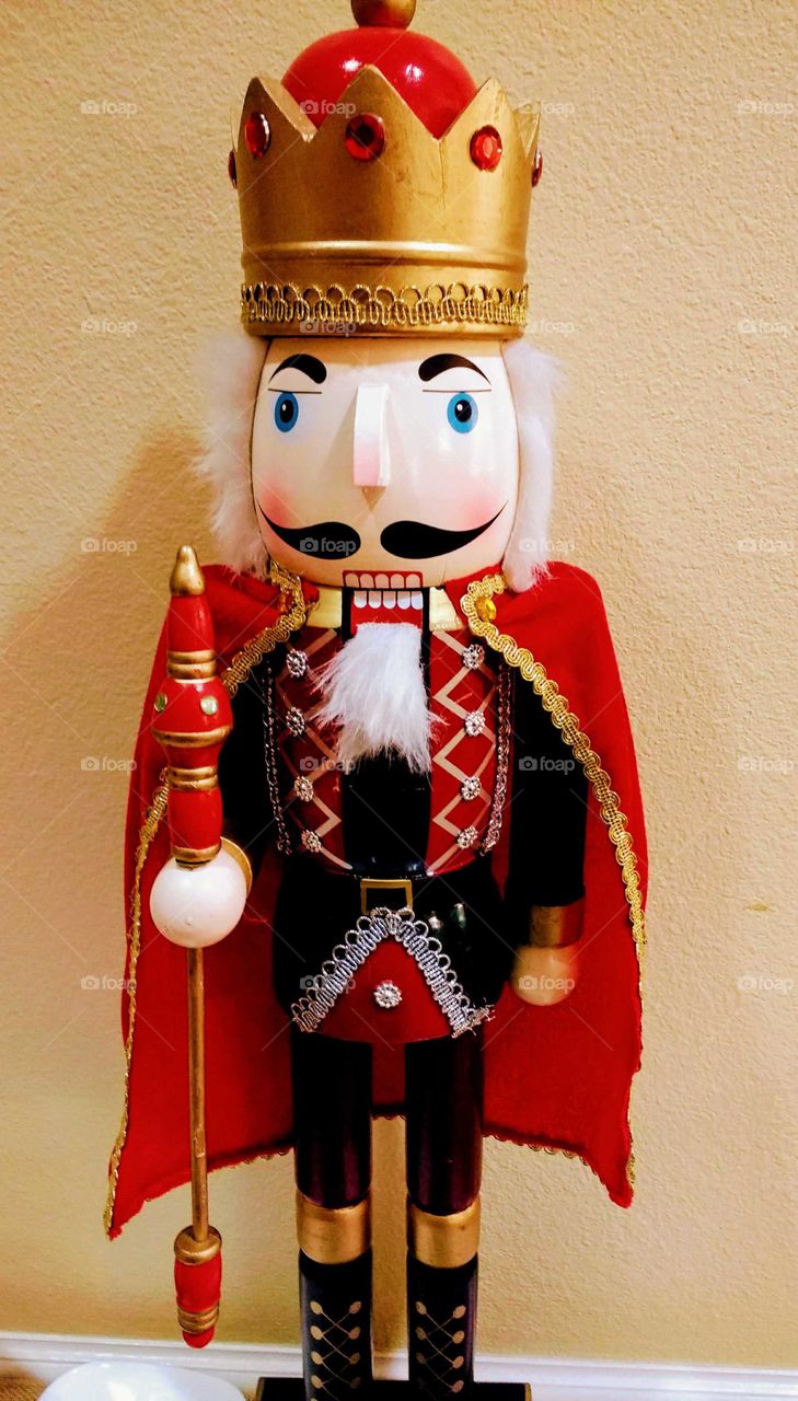 A bright red caped wooden nutcracker for Christmas