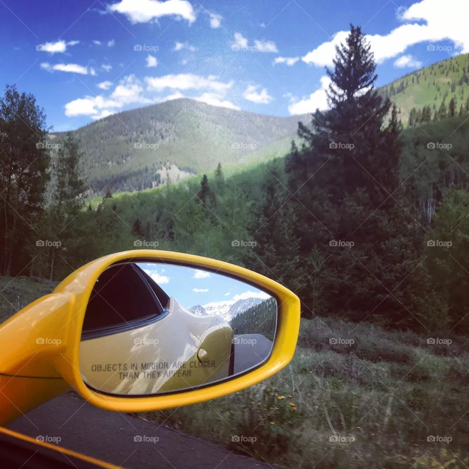 Mountain drive in Ferrari 458 side mirror view 