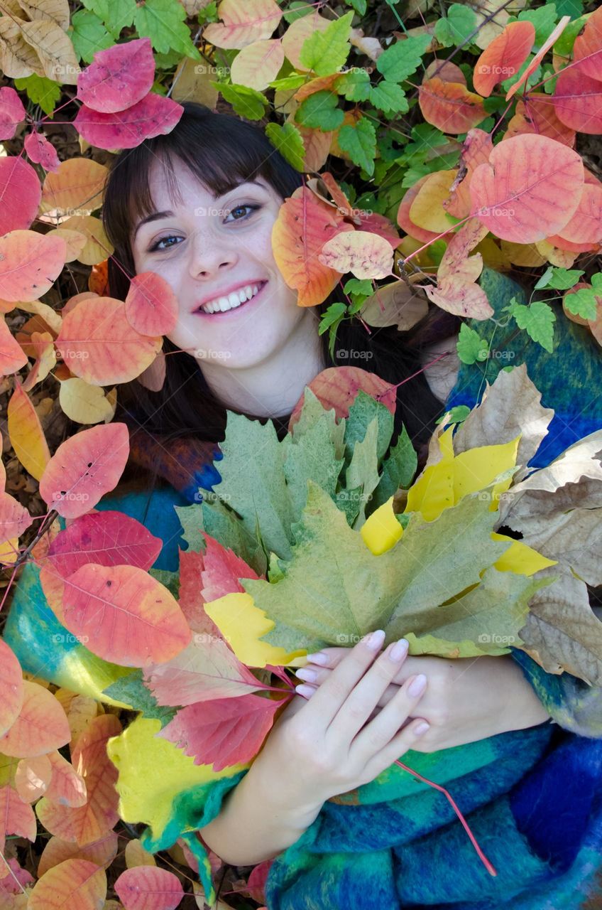 Portrait of smiling woman on autumn background