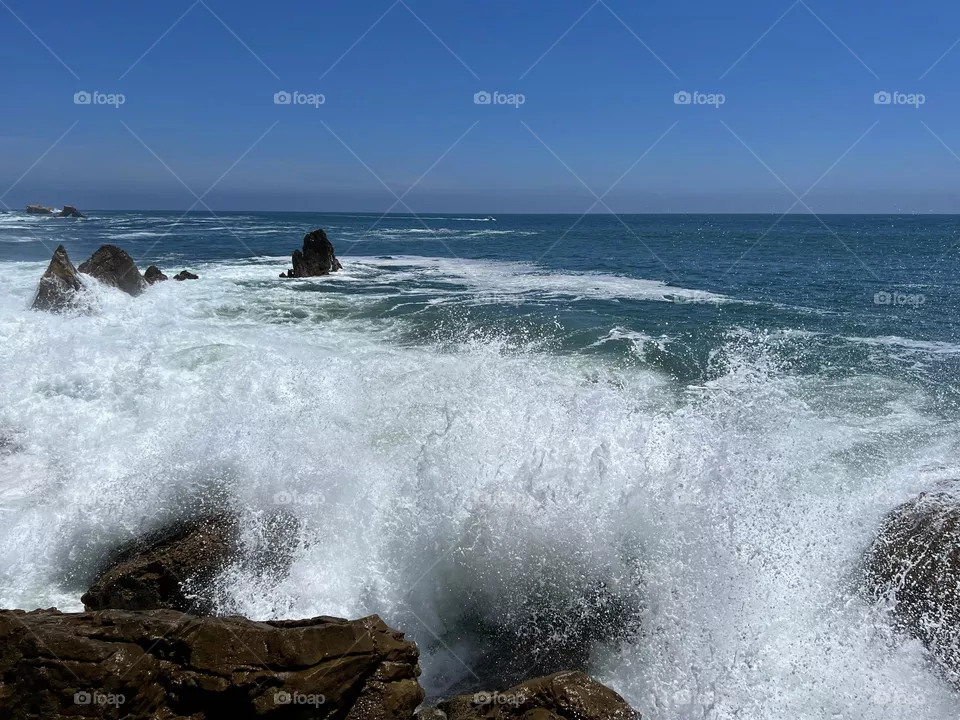 Huge wave crashing on Little Corona del Mar Beach
