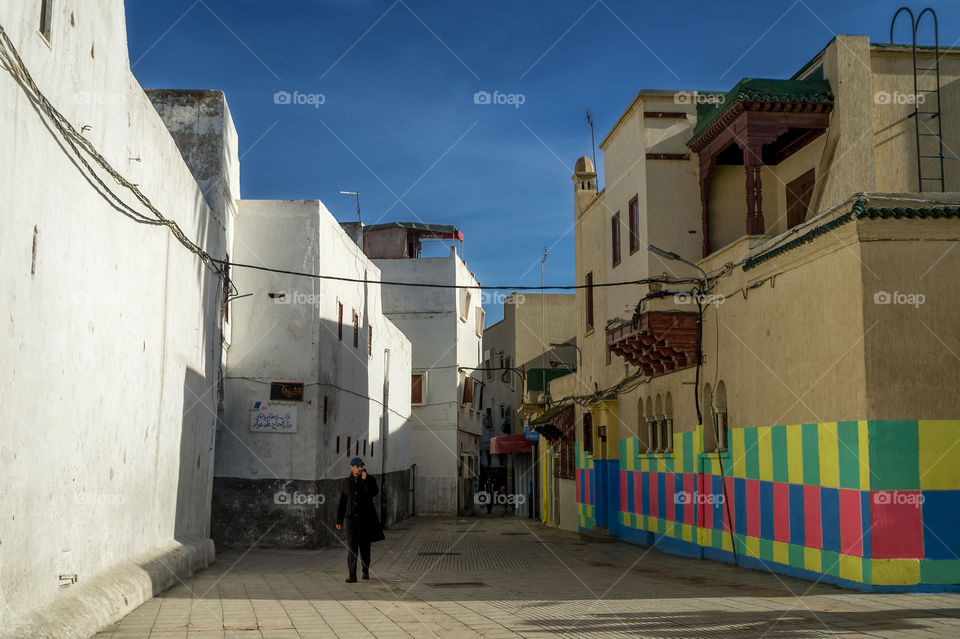 A street in the old city of Sale (Morocco) and the walls of houses against the background of the blue spring sun