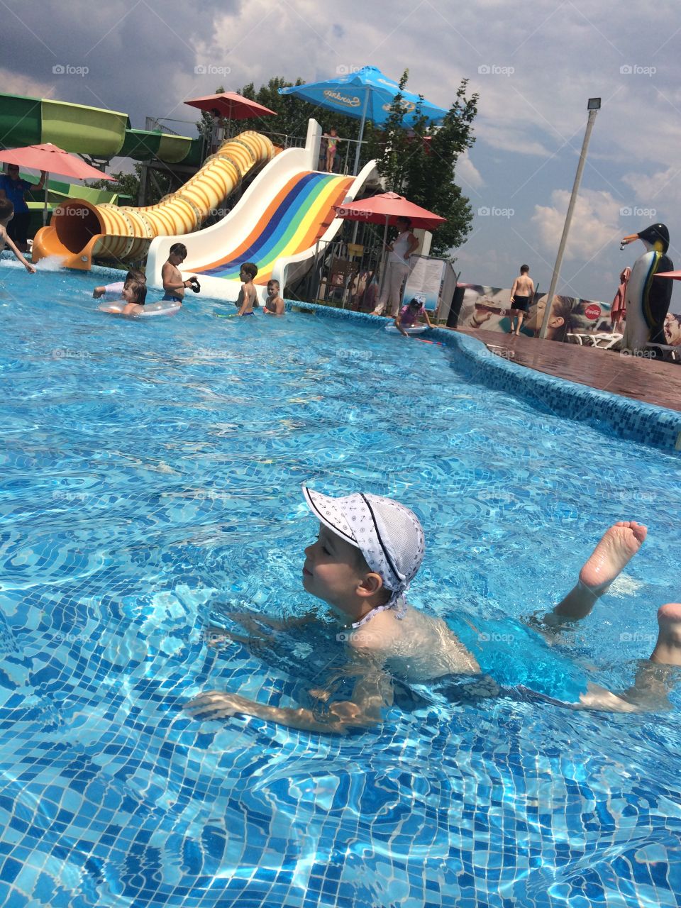 boy swims in the pool