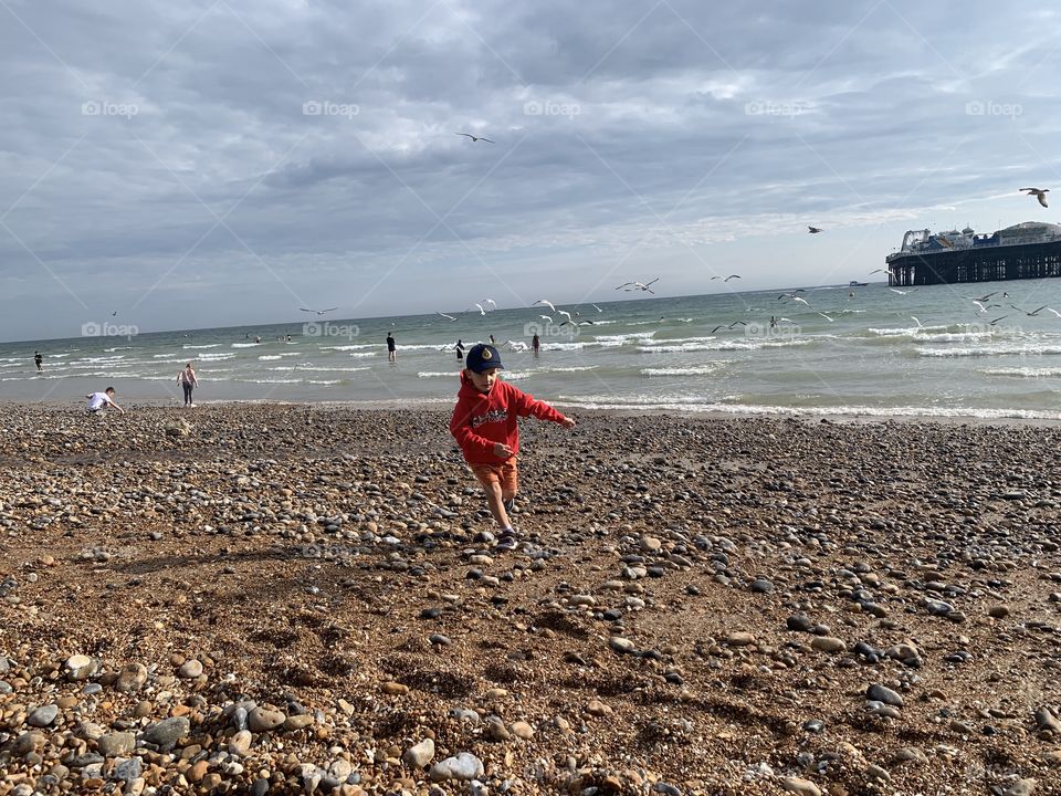 Little boy running on the beach 