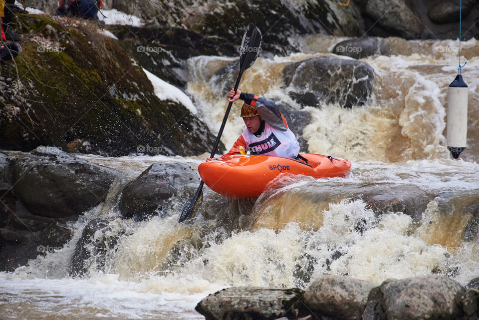 Helsinki, Finland - April 15, 2018: Unidentified racer at the annual Icebreak 2018 whitewater kayaking competition at the Vanhankaupunginkoski rapids in Helsinki, Finland.