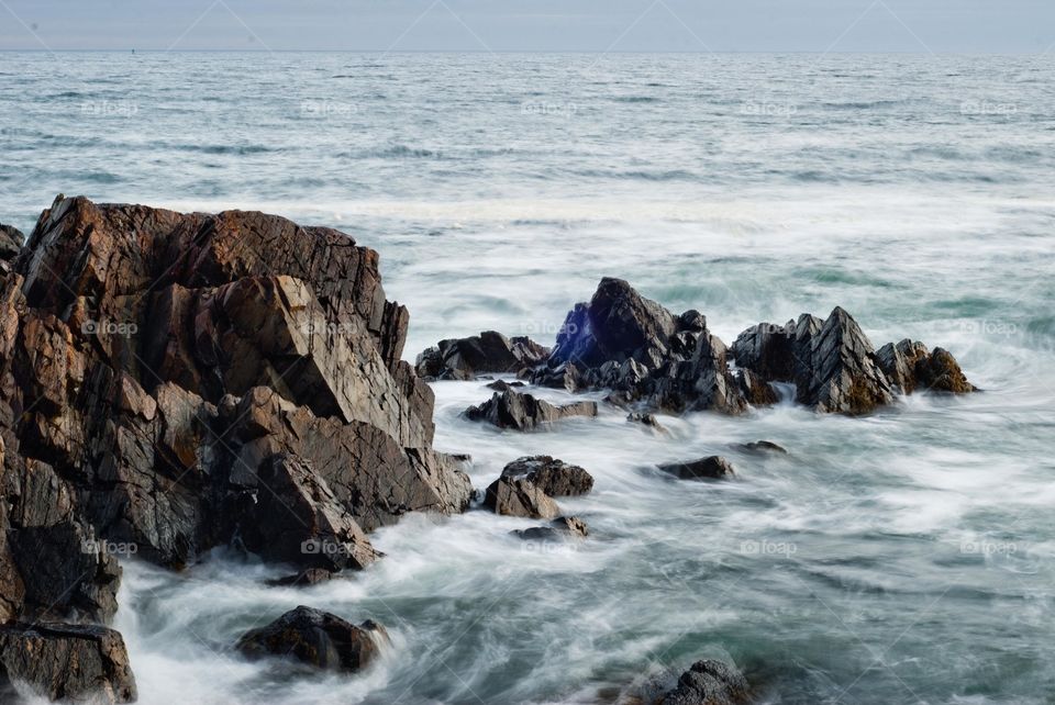 Water Rushing onto the Rocky Shores in Kennebunkport Maine