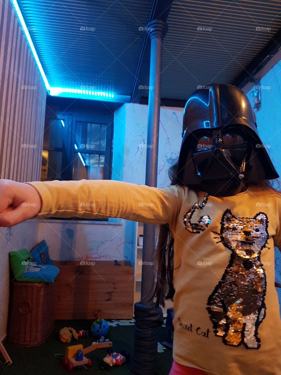 Girl playing with a Star Wars mask indoor