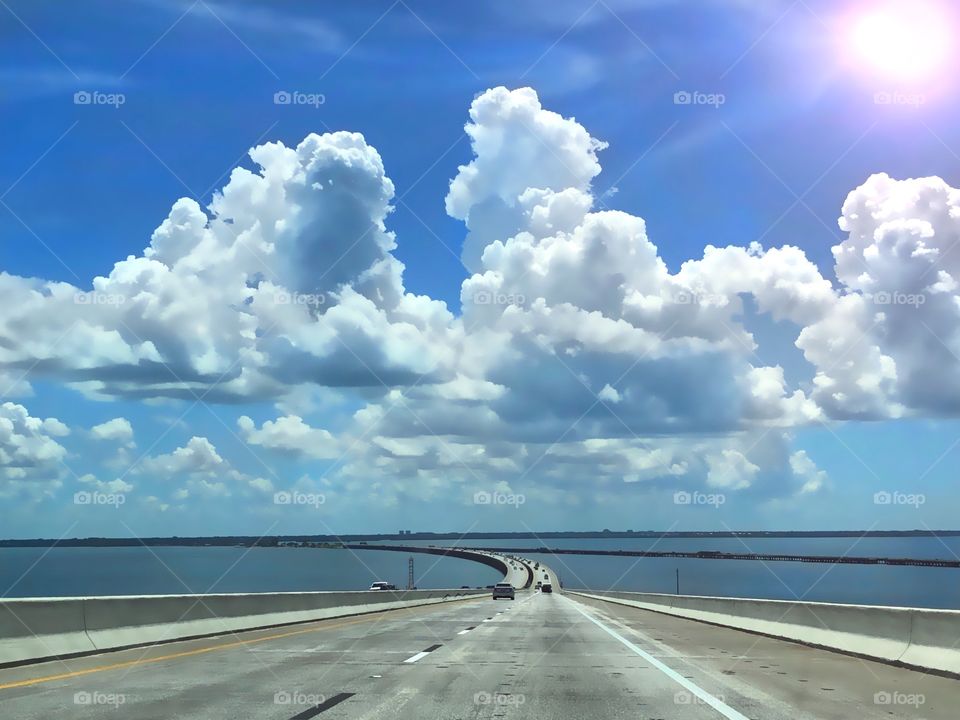 Skyway Highway with colorful cumulous clouds and bright sunshine.