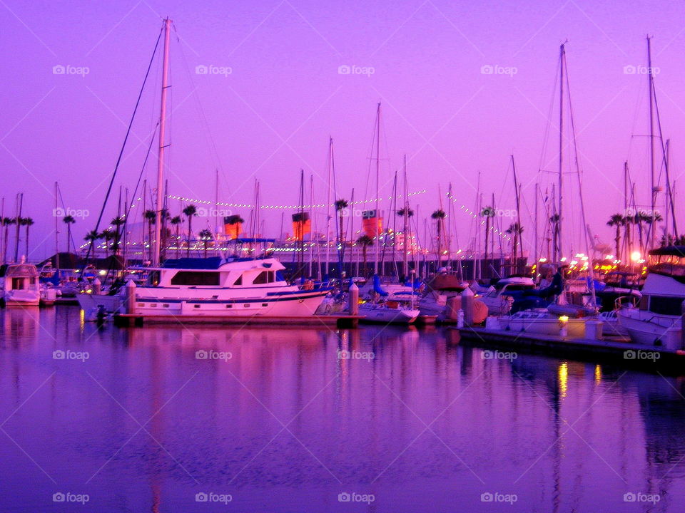 Sailboats in the harbor at the purple sunset