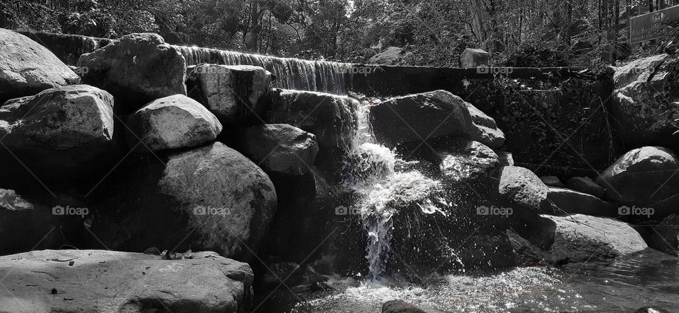 Falling on the rocks in deep forest...Black and white