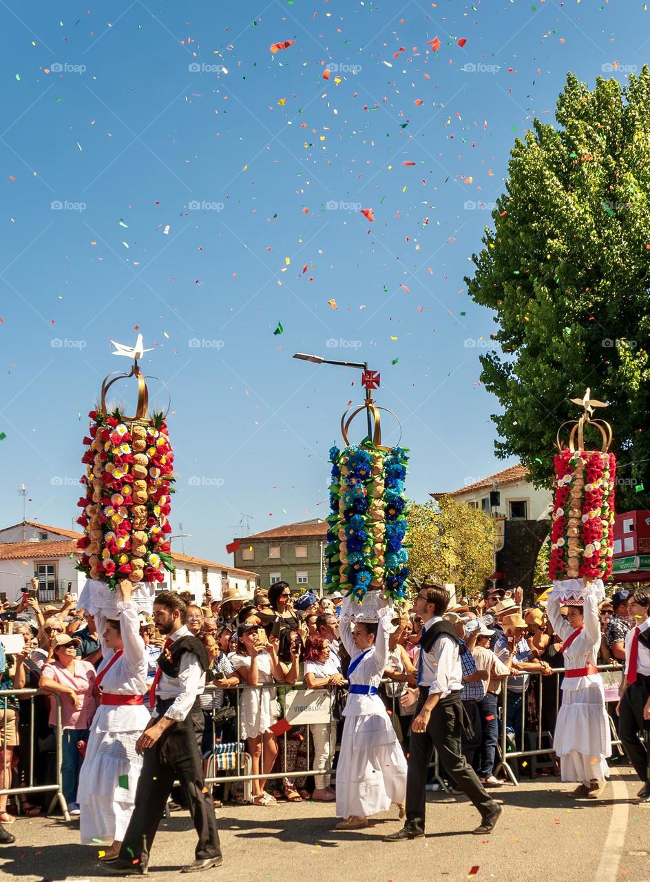 A crowd of people watch the Cortejo dos Tabuleiros for Festa Dos Tabuleiros in Tomar, Portugal 2023. 