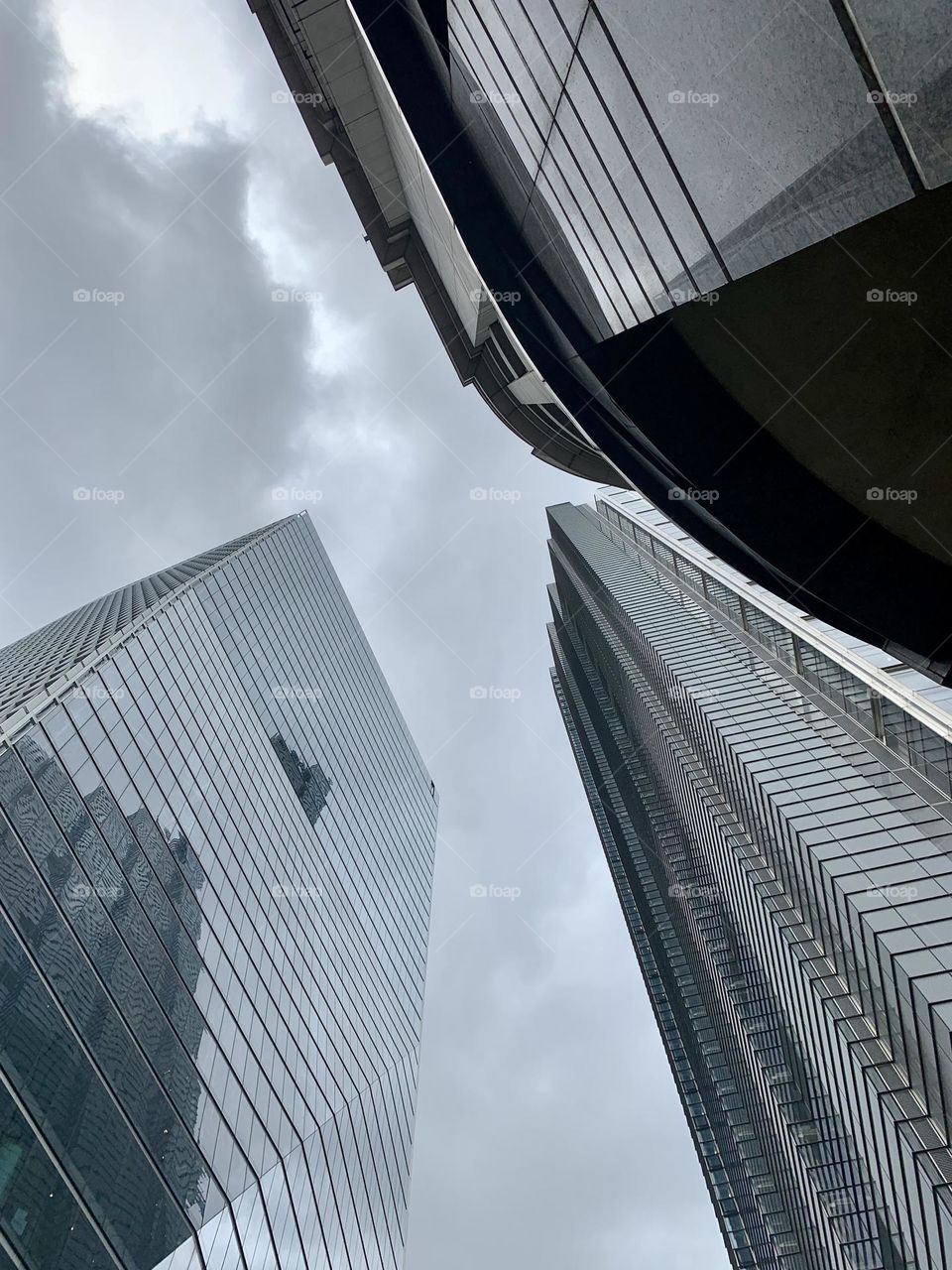 Low angle view of London skyscrapers, gray color palette, geometric buildings, geometry in architecture 