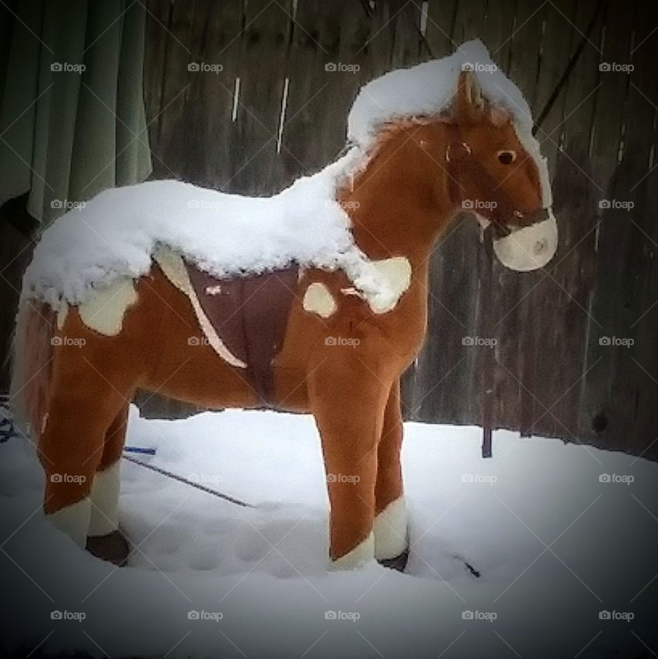 toy horse on snow