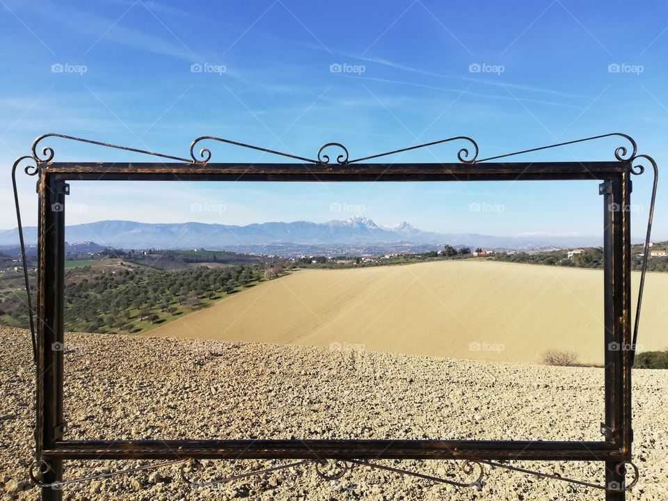 Wrought iron frame frames the Abruzzo landscape