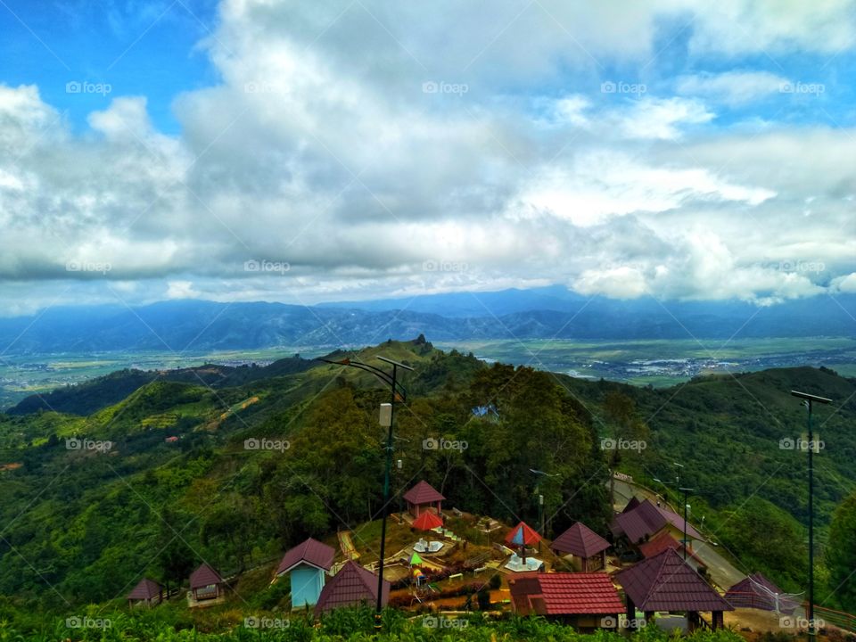 This is a view of the Kerinci Valley in the Indonesian Jambi Province from a hill that is named the hill of heaven, the hill is on the edge of the river city full of Indonesian Jambi Province on the island of Sumatra