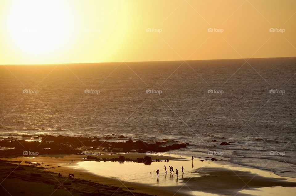 Boys playing football in the beach at sunset. Jericoacoara Brazil 