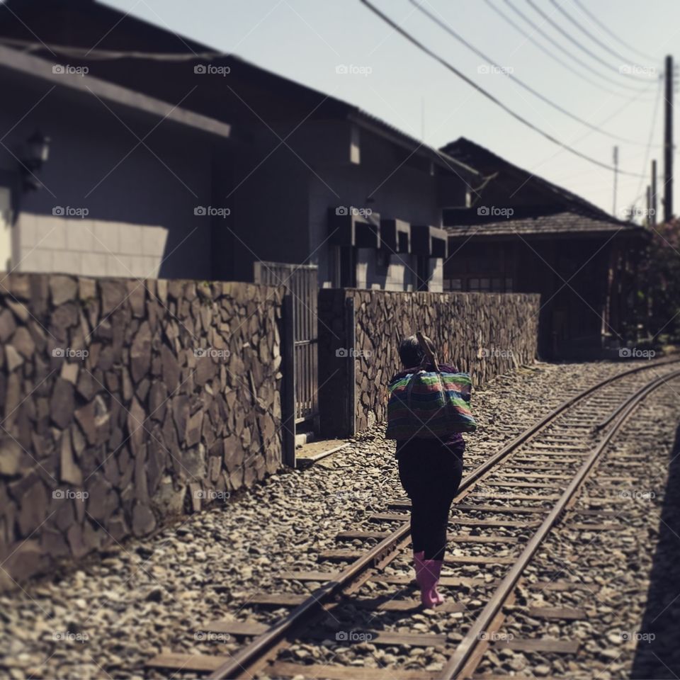 Old lady . Old lady walking on the old rail road 