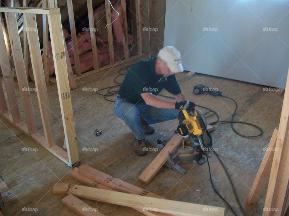 Hard at Work. Man working on building a home